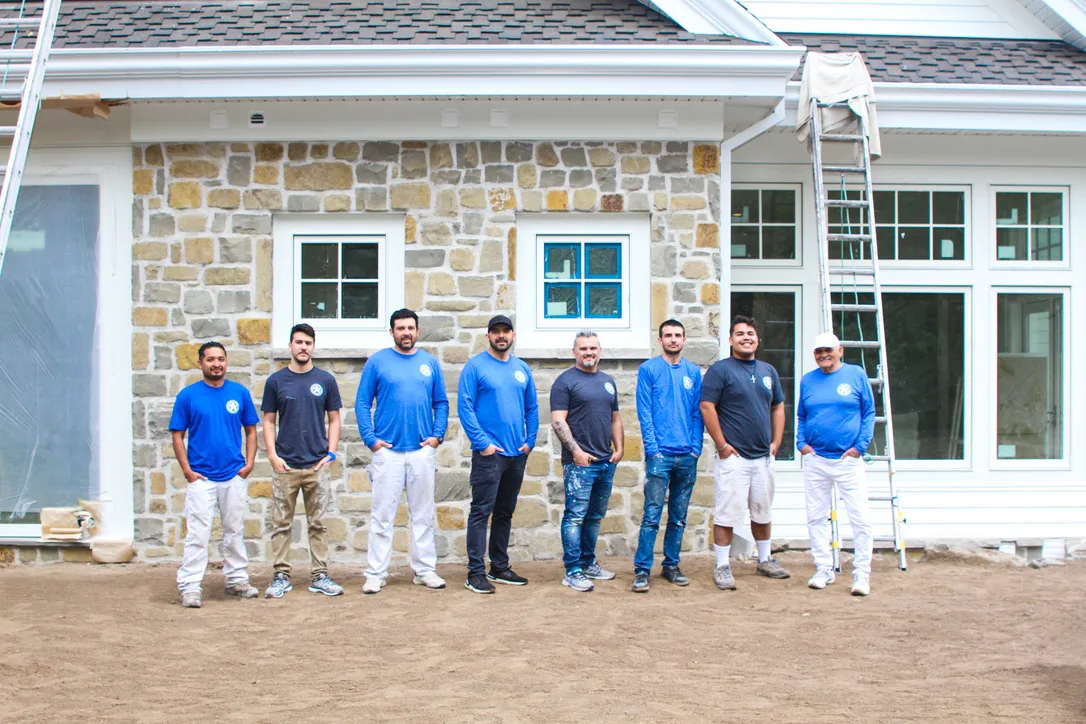 American Town Painting crew outside a stone house