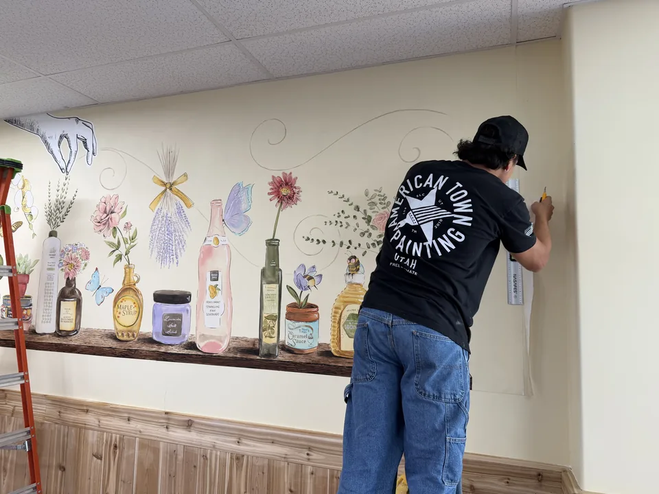 Crew installing a wall mural